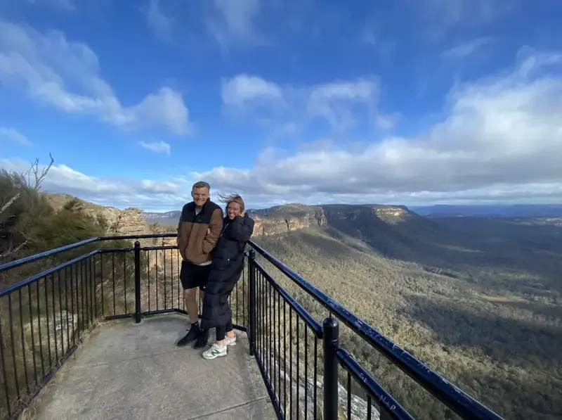 Visitors at a fenced mountain lookout