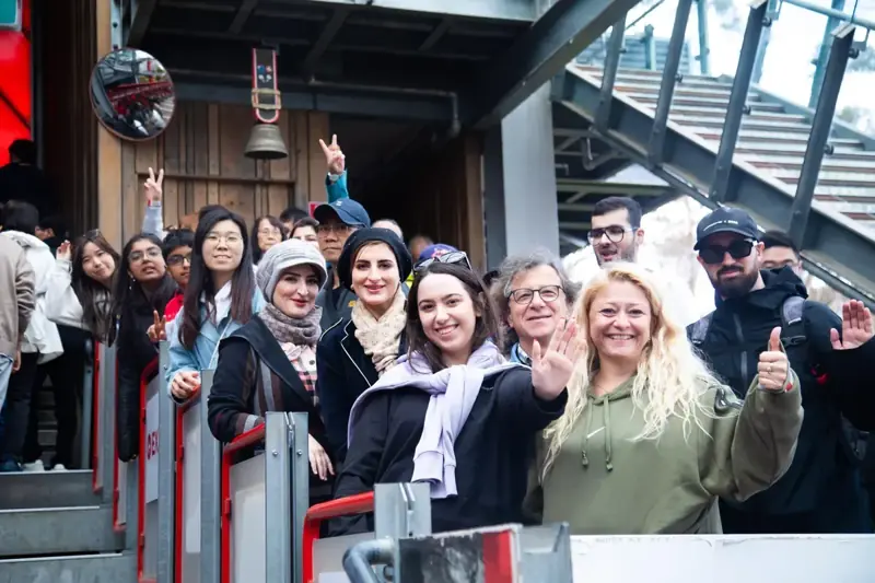 Tour group beside a ride entrance