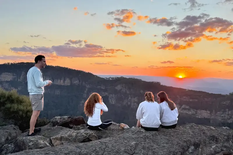 Small group watching sunset over the mountains